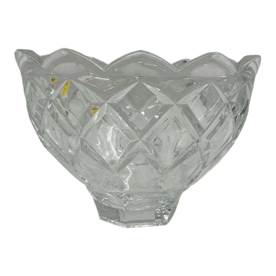 Cut Crystal Footed Centerpiece Bowl: Elegant clear cut crystal centerpiece bowl featuring a deep rounded form with a scalloped rim and bold crisscross diamondcut pattern. Raised on a faceted pedestal foot, the bowl offers exceptional bri