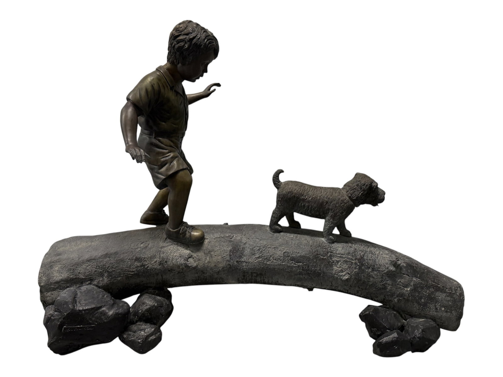 Lake Geneva Studios Monumental Bronze Sculpture of Boy and Dog Crossing a Log: Large-scale cast bronze figural sculpture by Lake Geneva Studios depicting a young boy and his dog carefully making their way across a fallen tree trunk. The boy is modeled mid-step with arms extended