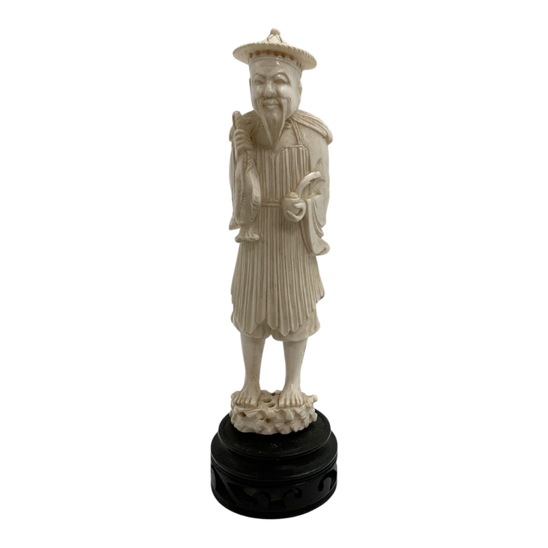 Asian-Style Carved Bearded Elder with Conical Hat Sculpture: A detailed Asian-style carved figural sculpture depicting a standing bearded elder wearing a traditional conical hat and layered garments. The figure is rendered with an expressive face, long beard, a