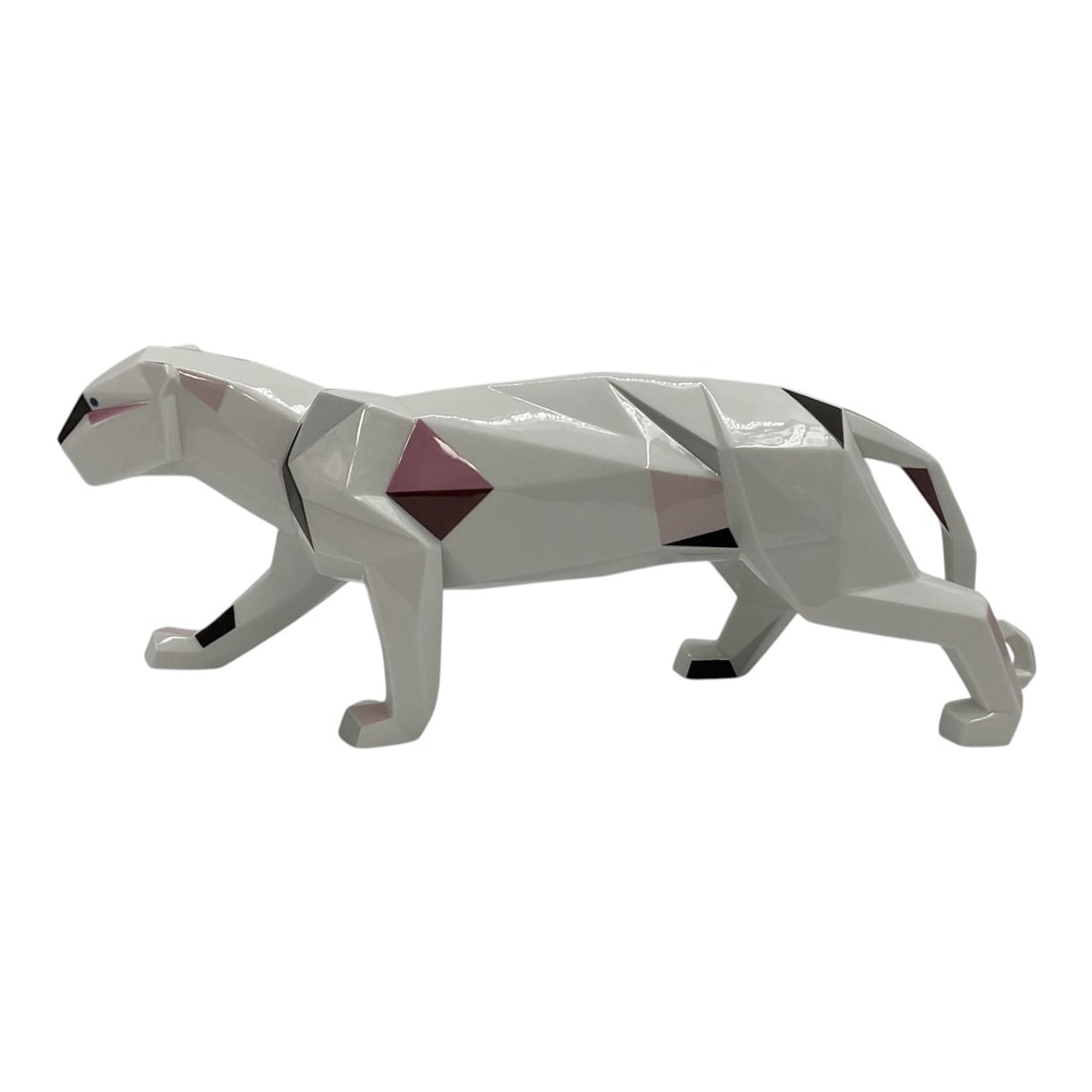 "Panther (Red Details)" by Lladró (Spain, 1953-) Porcelain: This contemporary glossy porcelain sculpture depicts a walking panther rendered in a faceted, geometric style. The piece features a smooth white glaze accented with striking geometric color blocks in 