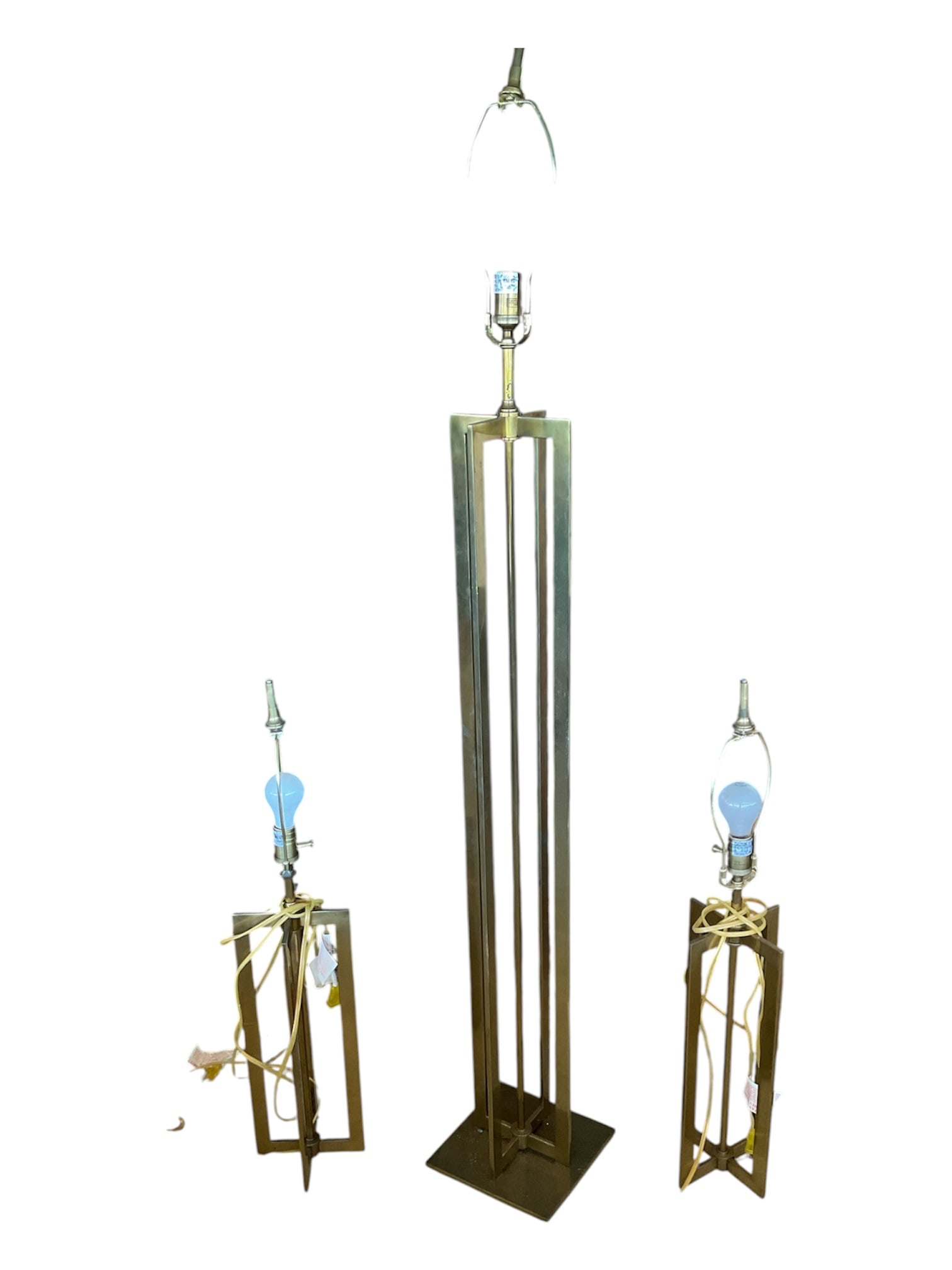 Vintage Hollywood Regency Geometric Brass Lamp Set, 3 Pieces: A coordinated three-piece vintage lighting set in the Hollywood Regency style, comprising one tall floor lamp and two matching table or accent lamps. Each features an architectural open-frame geometri