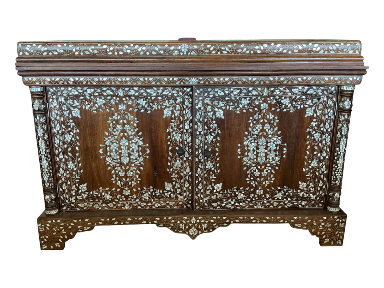 Indian Teakwood Mother-of-Pearl Inlaid Cabinet with Floral Vine Decoration: A richly decorated Indian teakwood cabinet featuring extensive hand-inlaid mother-of-pearl decoration arranged in elaborate scrolling floral and foliate patterns. The rectangular cabinet is fitted wit