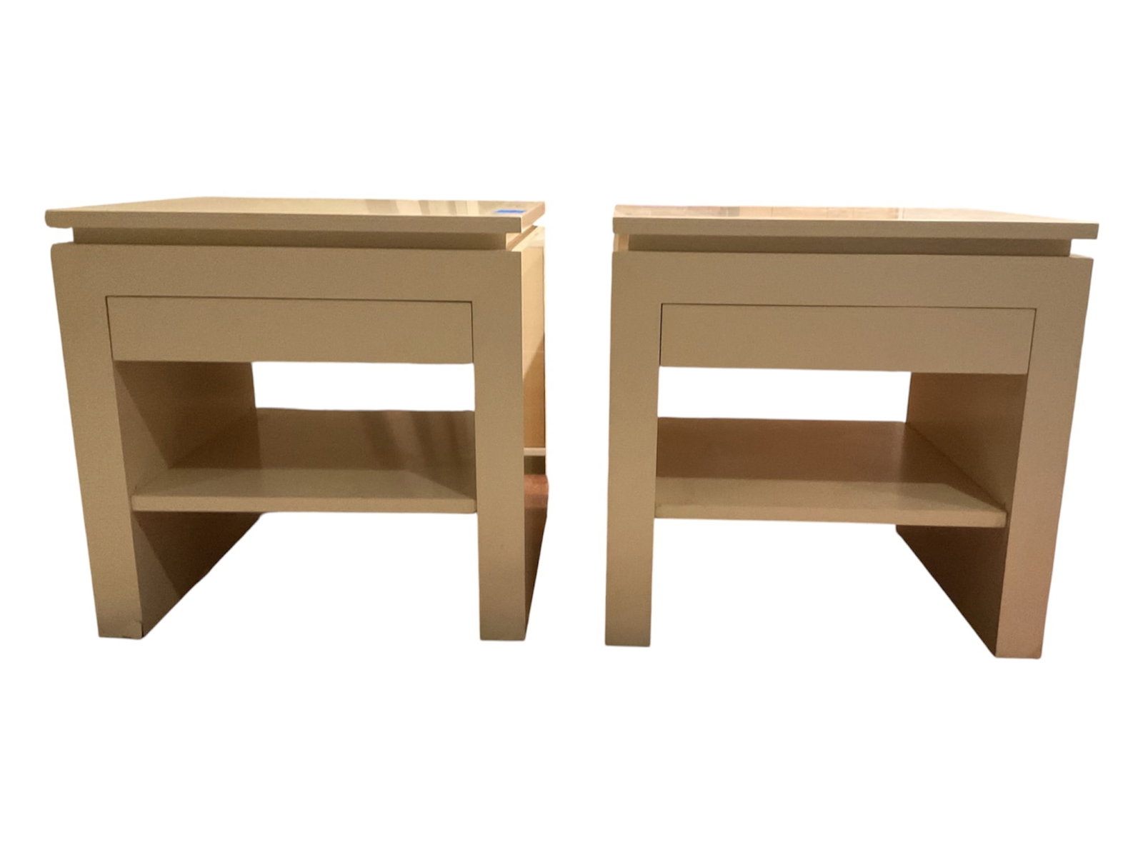 Pair of Modern White Lacquer Nightstands: Matching pair of modern bedside tables featuring clean architectural lines and a warm white lacquered finish. Each nightstand is designed with a broad square top, a single flush-front storage drawer w