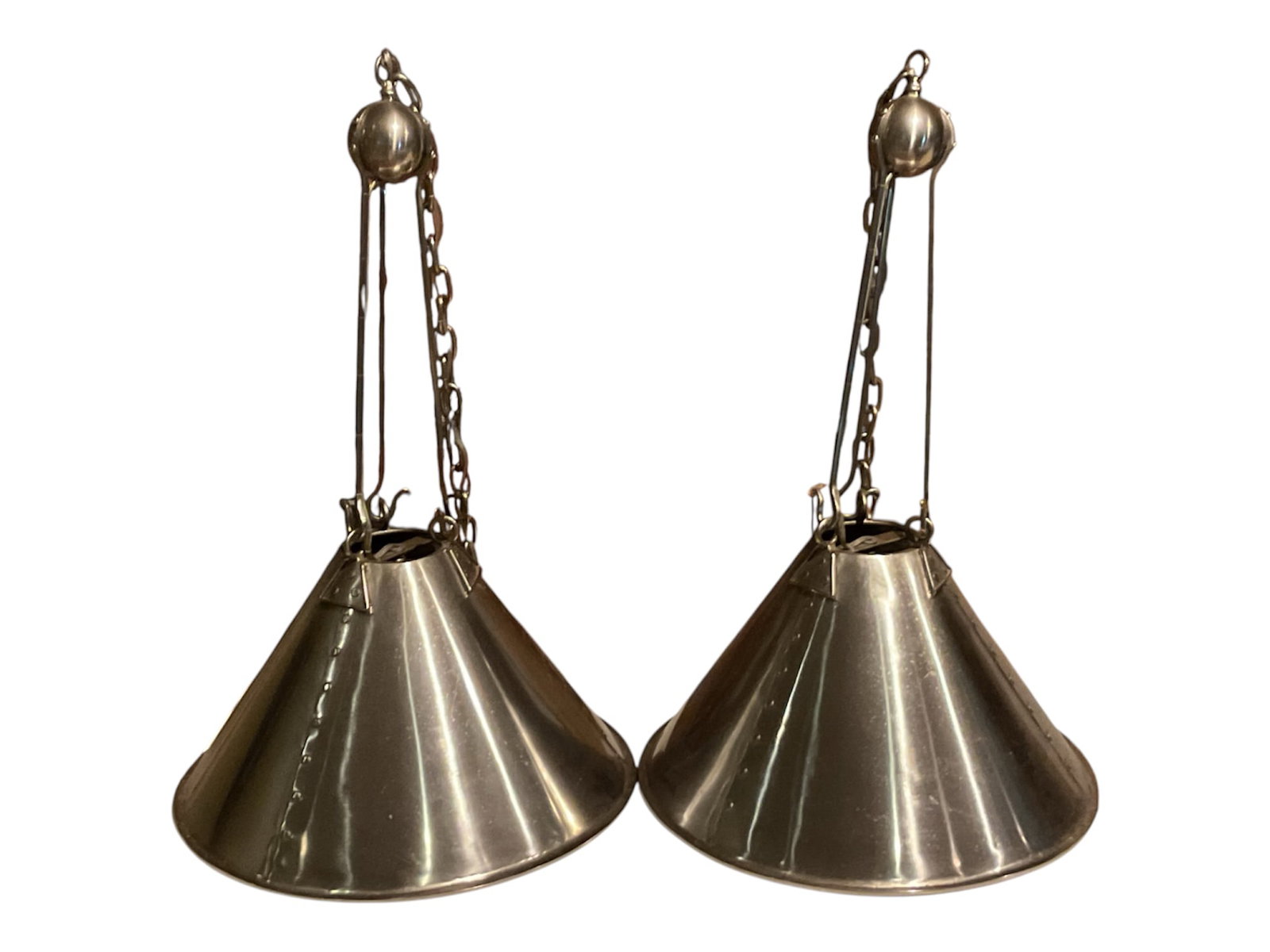 Pair of Paul Ferrante “Theo?? Hanging Fixtures: Pair of Theo Hanging Fixtures by Paul Ferrante, model 2038, featuring broad conical metal shades suspended from elongated supports with decorative chain and spherical ceiling elements. The fixtures ex