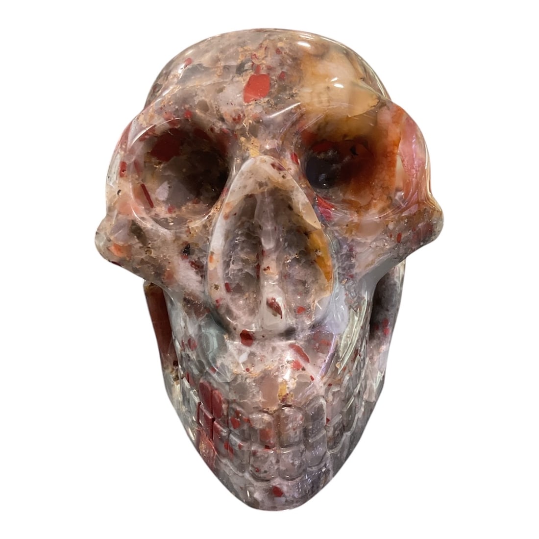 AG001 - Carved Agate Skull Sculpture: A striking and contemporary carved agate skull, showcasing the natural beauty and complexity of the stone through expert craftsmanship. This sculptural piece blends organic material with bold form, re