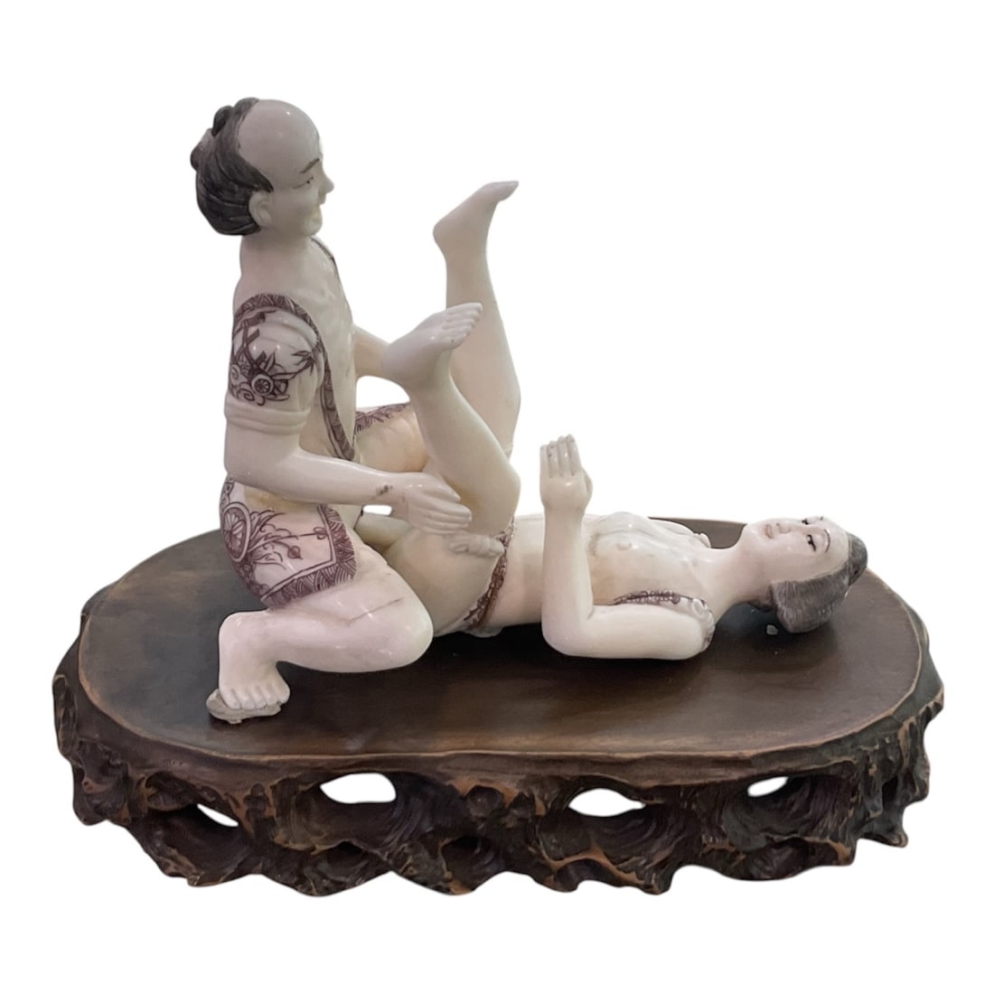 IC1306 - Carved Asian Erotic Figural Group on Hardwood Base: A finely carved figural group depicting an inti