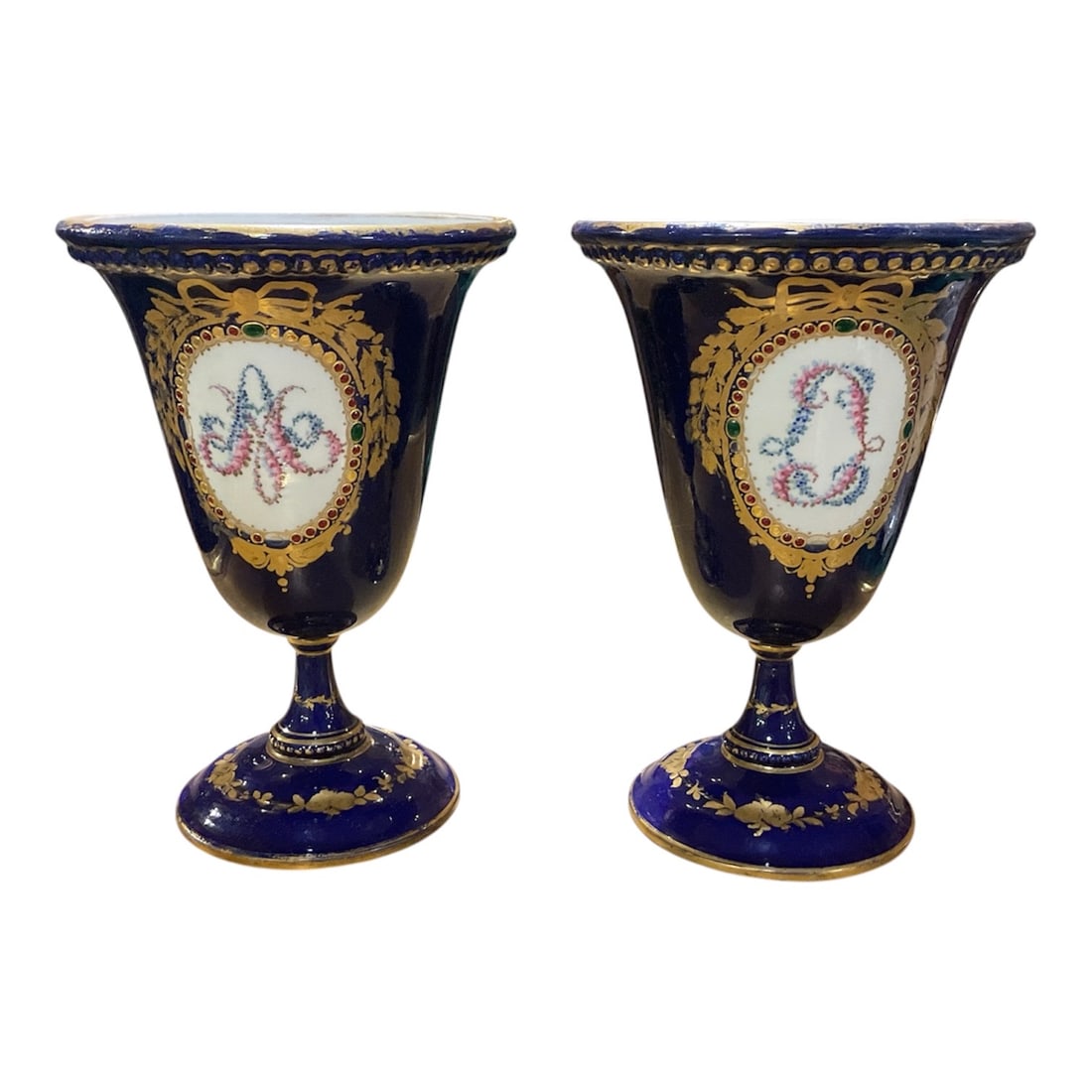 PC657 - Pair of Sevres, Cobalt Blue Porcelain Vases with Romantic Figural Reserves: A richly decorated pair of Sevres, porcelain vases featuring a deep cobalt blue ground enhanced with elaborate gilt ornamentation and finely painted romantic figural scenes. Each vase is elegantl
