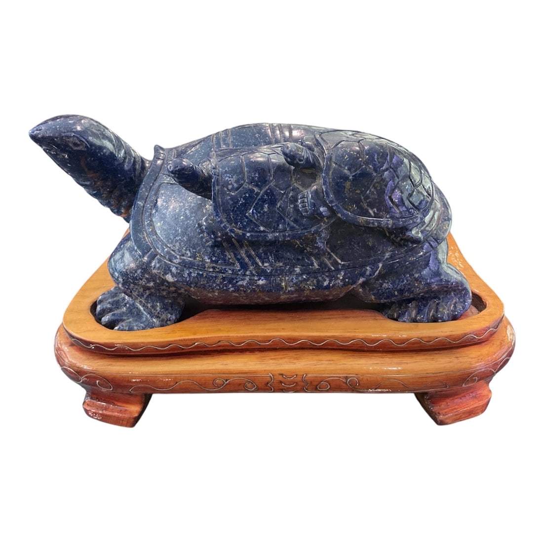 LC005 - Carved Lapis Lazuli Turtle with Figure on Hardwood Stand: A finely carved lapis lazuli sculpture depicting a stylized turtle, a symbol of longevity, stability, and protection in many cultures, particularly in Asian tradition. This substantial and visually