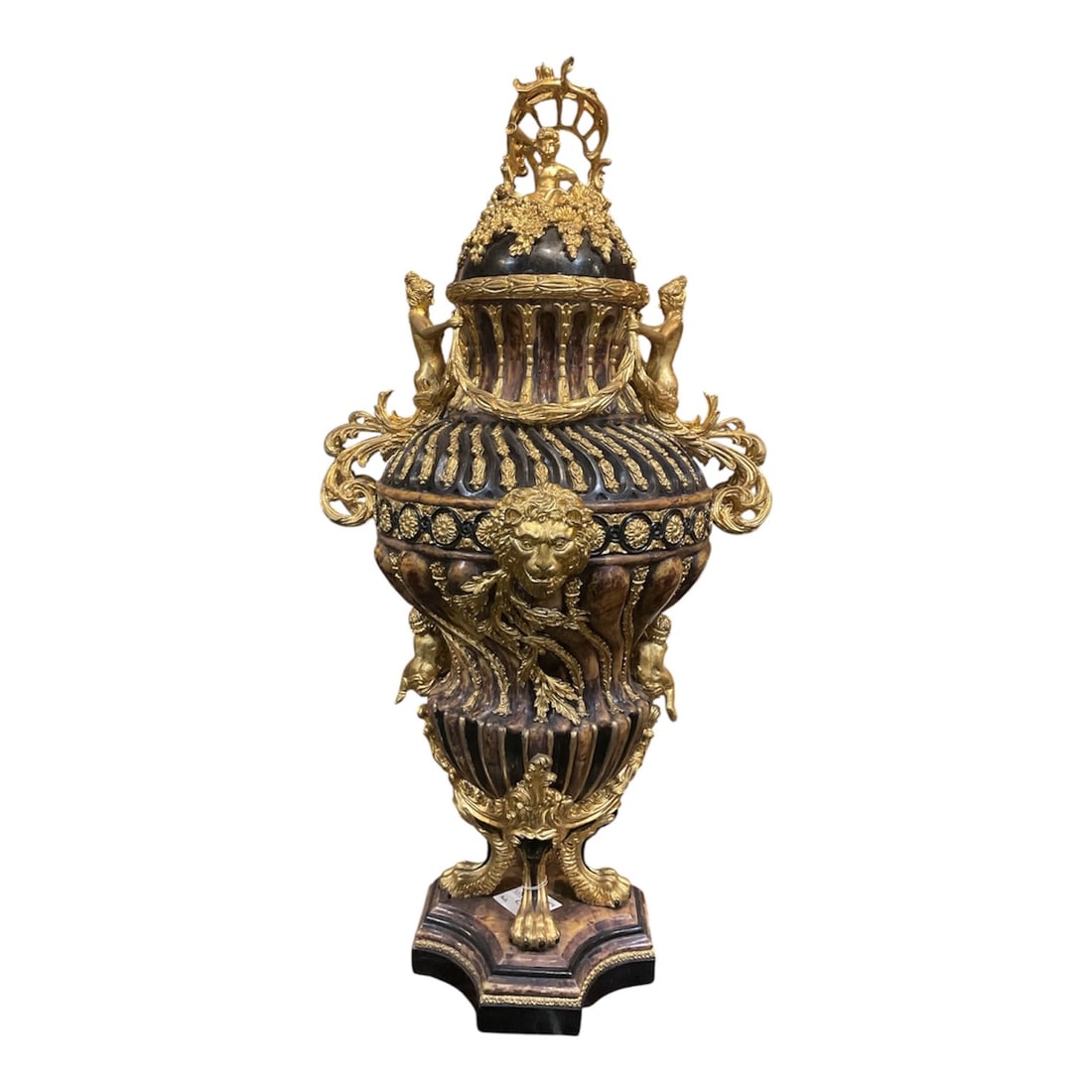 PC947 - Brown Shell Form Urn with Figural and Dore Bronze Mounts: A highly ornate and sculptural decorative urn featuring a richly textured brown shell-form body accented with elaborate gilt mounts and figural elements. The urn is executed in a dramatic classical st