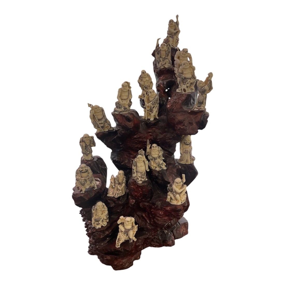 IC1088 - Carved Asian Figure Group of Eighteen Lohans on Hardwood Base: A finely detailed carved group depicting the Eighteen Lohans (Arhats), revered disciples of the Buddha, traditionally associated with wisdom, protection, and enlightenment. This sculptural composition