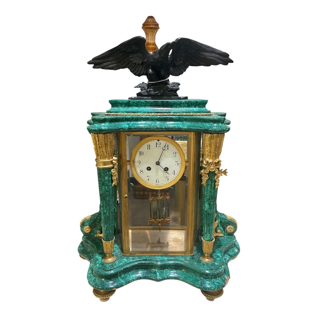 AQ054 - 19th Century French Empire Style Malachite and Dore Bronze Mantel Clock: A distinguished mantel clock executed in the French Empire style, featuring a richly figured malachite case adorned with finely cast dore bronze mounts. The rectangular case is a vibrant green malachi
