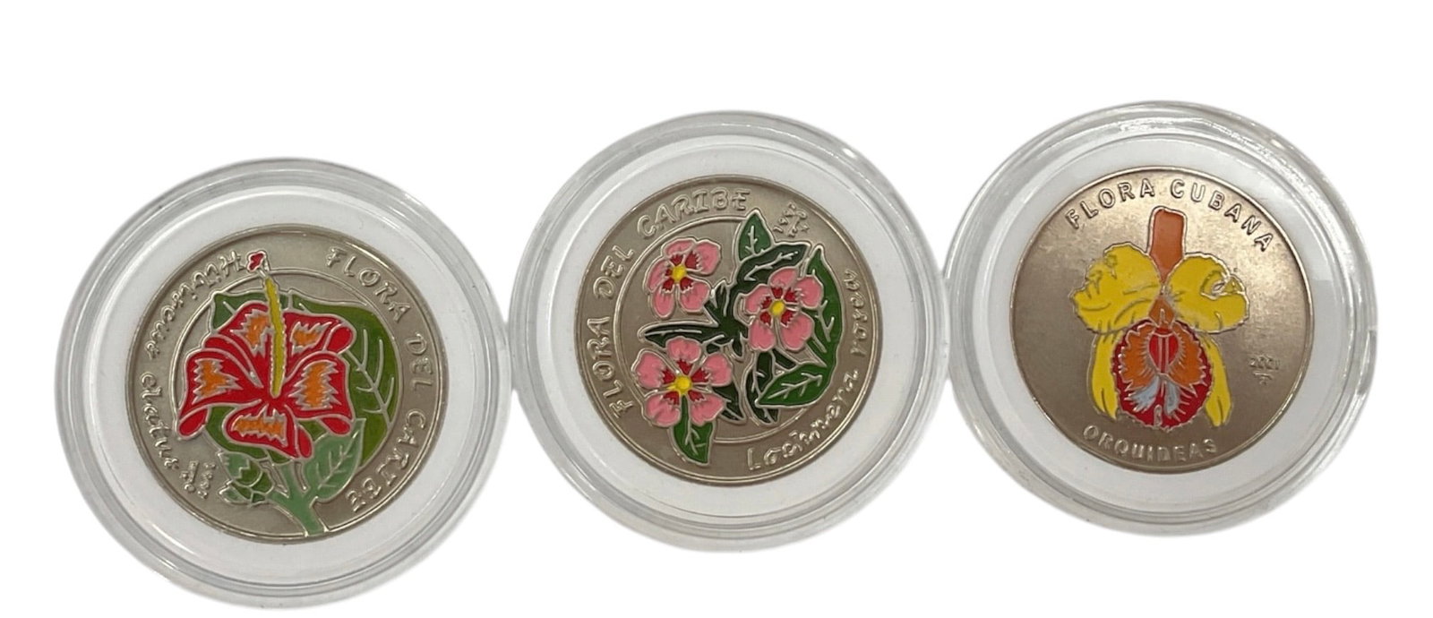 Set of Three Republic of Cuba Colorized Flora 1 Peso Commemorative Coins: Set of three Republic of Cuba colorized 1 peso commemorative coins housed in individual protective capsules. Each coin features a different vividly colorized Cuban flower on the obverse, including var