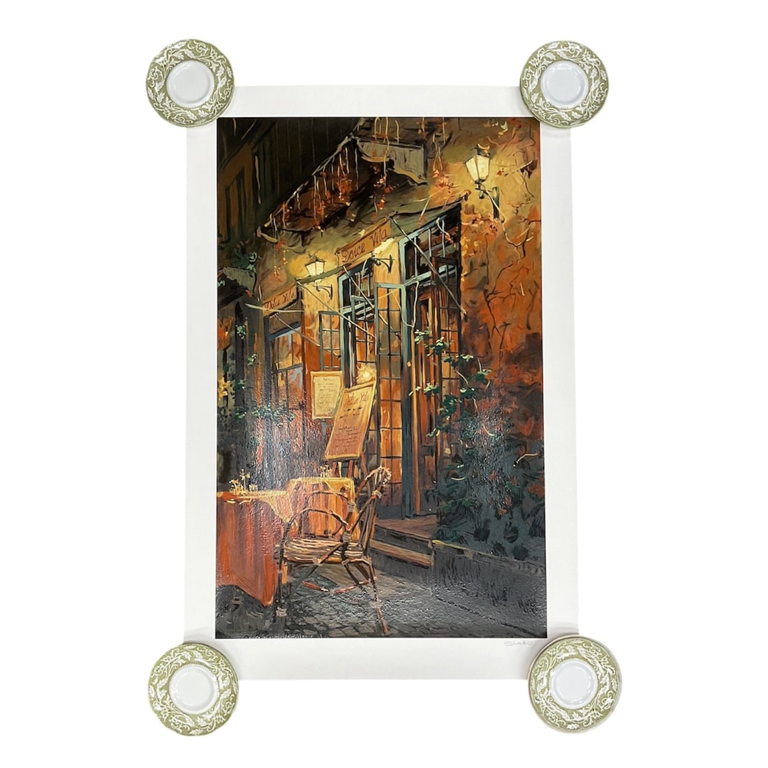 "Romantic Evening" by artist Viktor Shvaiko, Limited Edition Serigraph: This limited edition serigraph by Shvaiko depicts a warmly illuminated streetscape featuring a wicker chair outside a quaint storefront. Richly textured brushwork and glowing amber, brown, and gold to