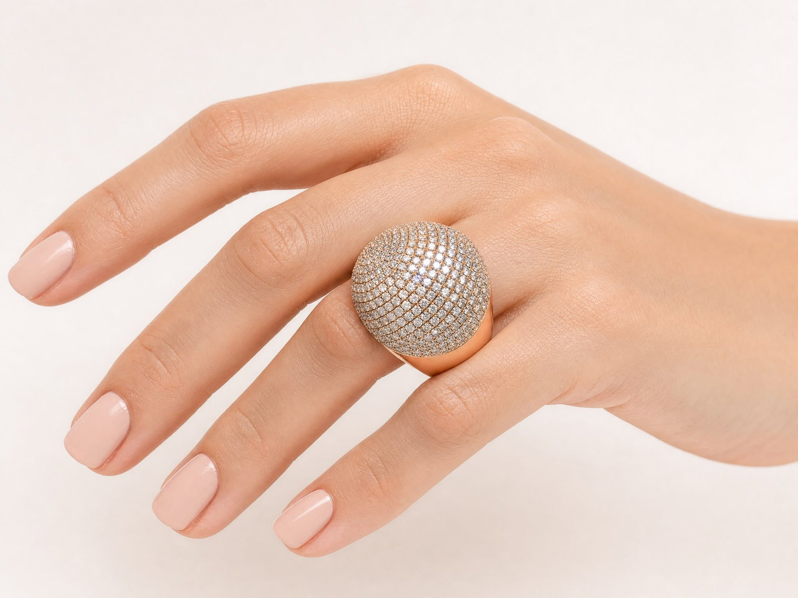 Rose Gold PavÃ© Diamond Dome Ring: A bold and luxurious rose gold dome ring featuring an expansive pavé-set diamond surface in a dramatic spherical design. The ring is densely set with numerous sparkling diamonds across the dome