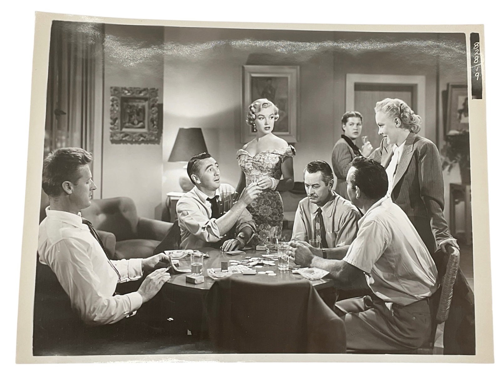 "Marilyn Monroe in 'How to Marry a Millionaire'" Silver Gelatin Print Type 1: A vintage silver gelatin production still photograph from the 1953 Twentieth Century-Fox romantic comedy film "How to Marry a Millionaire." The scene features Marilyn Monroe as Schatze Page 