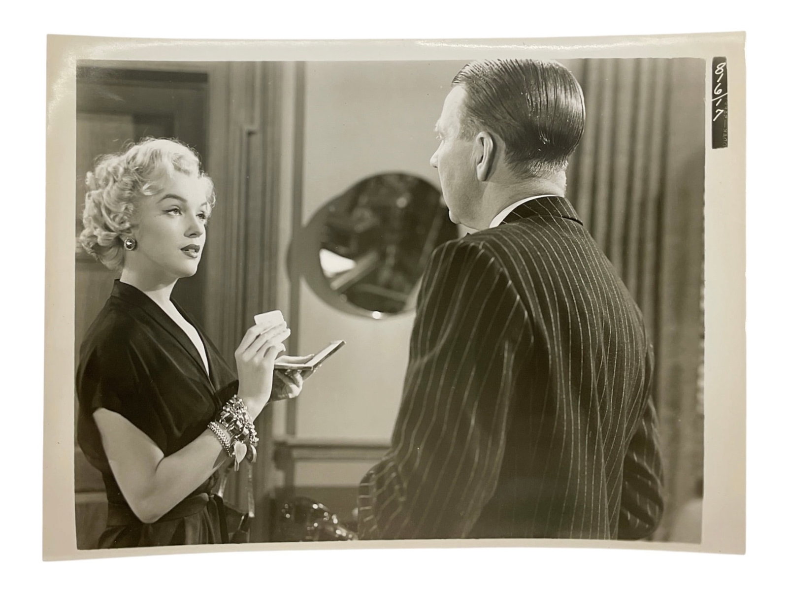 "As Young as You Feel" 1951 Marilyn Monroe Film Silver Gelatin Print: A vintage silver gelatin production still photograph from the 1951 Twentieth Century-Fox comedy film "As Young as You Feel." The image captures Marilyn Monroe in her role as Harriet, a glamo