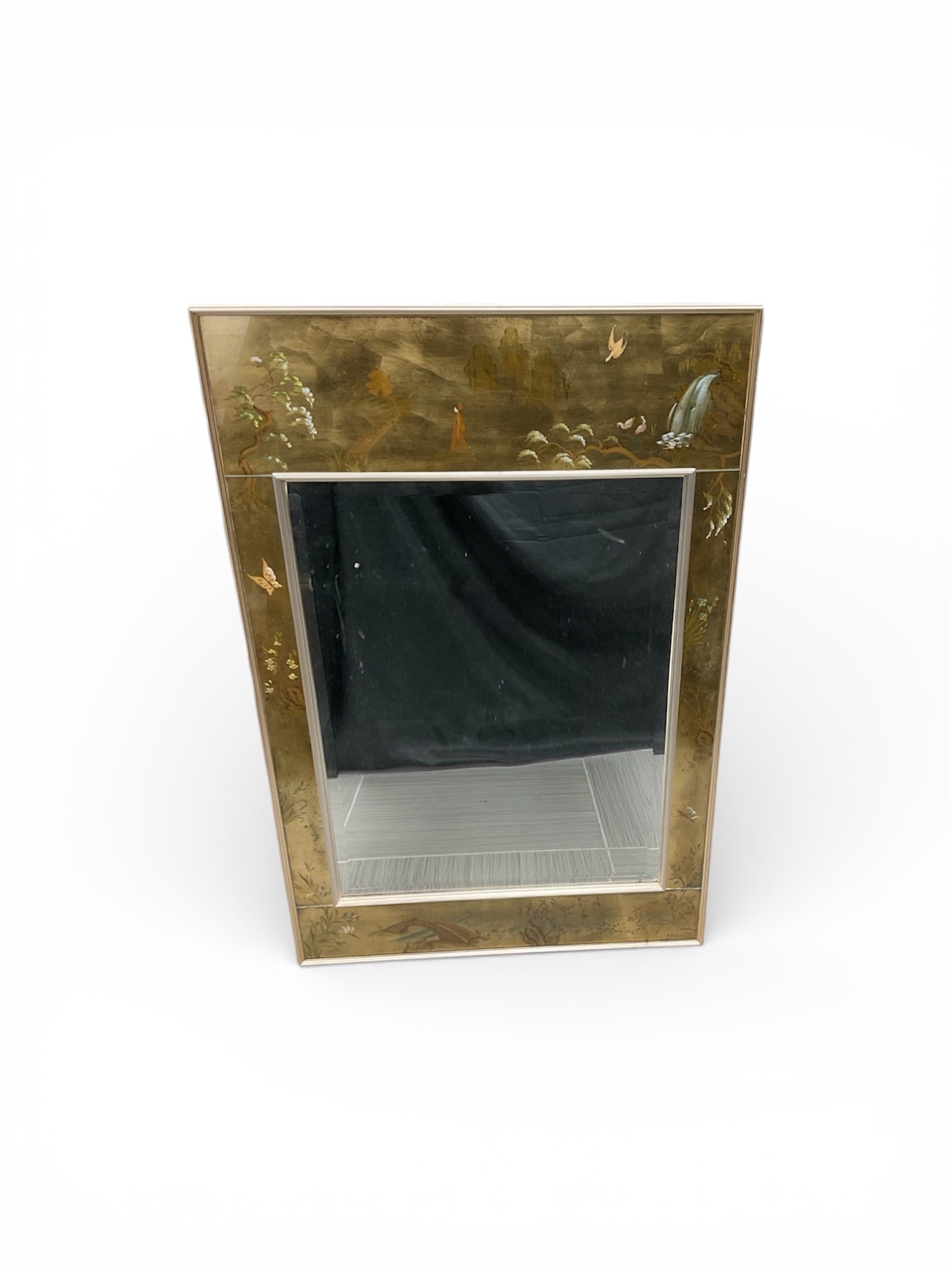 Vintage Chinoiserie Brass Mirror with Etched Floral and Butterfly Details: This striking vintage wall mirror features a trapezoidal brass frame heavily inspired by East Asian Chinoiserie design. The wide brass borders are meticulously etched and inlaid with decorative motifs