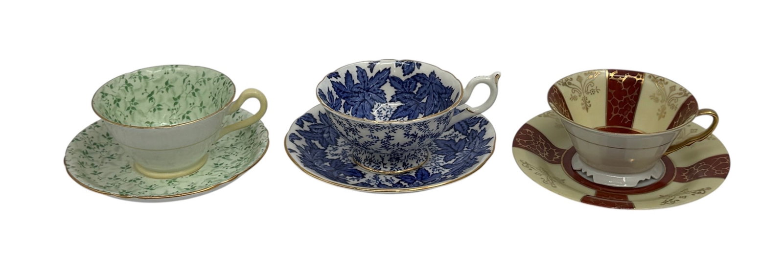 Three English Bone China Teacups and Saucers Including Copelands, Coalport, and Grosvenor: A grouping of three English bone china teacups with matching saucers produced by notable English porcelain manufacturers. The set includes examples by Copelands, Coalport, and Grosvenor China, each de