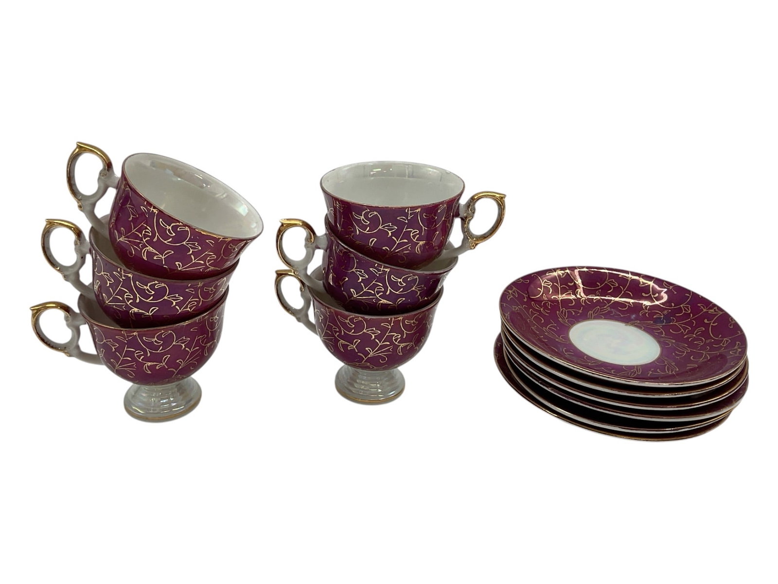 Vintage Burgundy Porcelain Teacups and Saucers,: This collection includes vintage burgundy porcelain teacups and saucers, characterized by an elegant deep red finish with intricate