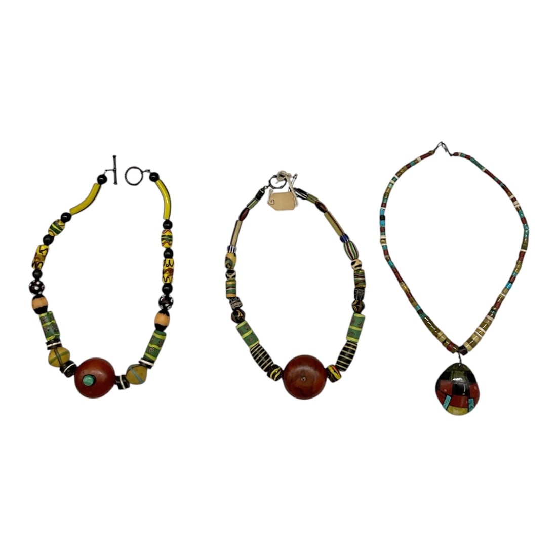 Group of Three Beaded Fashion Necklaces: Collection of three beaded fashion necklaces featuring multicolor beads, cylindrical accents, and decorative pendants in eclectic bohemian-inspired styles. Two necklaces feature large central round