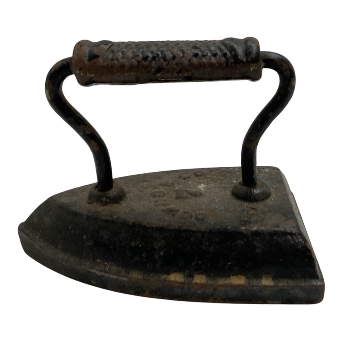 Antique Cast Iron Sad Iron with Metal Handle: Antique cast iron sad iron featuring a heavy triangular solid-iron base with an arched metal handle and textured cylindrical grip. This traditional household iron predates modern electric irons and wa