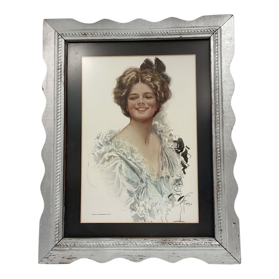 Harrison Fisher (American, 1875-1934) Framed Lady Portrait Print: An illustration depicting a smiling young woman with styled brown hair tied with a black hair bow. She is rendered in soft pastels and watercolors, wearing an ornate, frilled light blue gown with lace