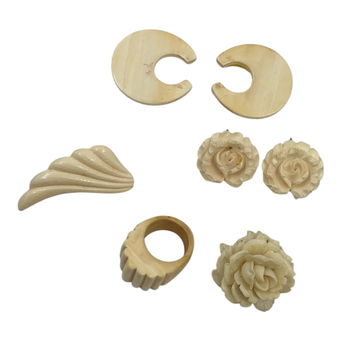 Vintage Carved Jewelry Group Including Ring and Earrings: A collection of vintage carved jewelry featuring floral and organic motifs. The group includes a deeply carved floral ring, a pair of carved rose-form earrings with post backs, a large carved fl
