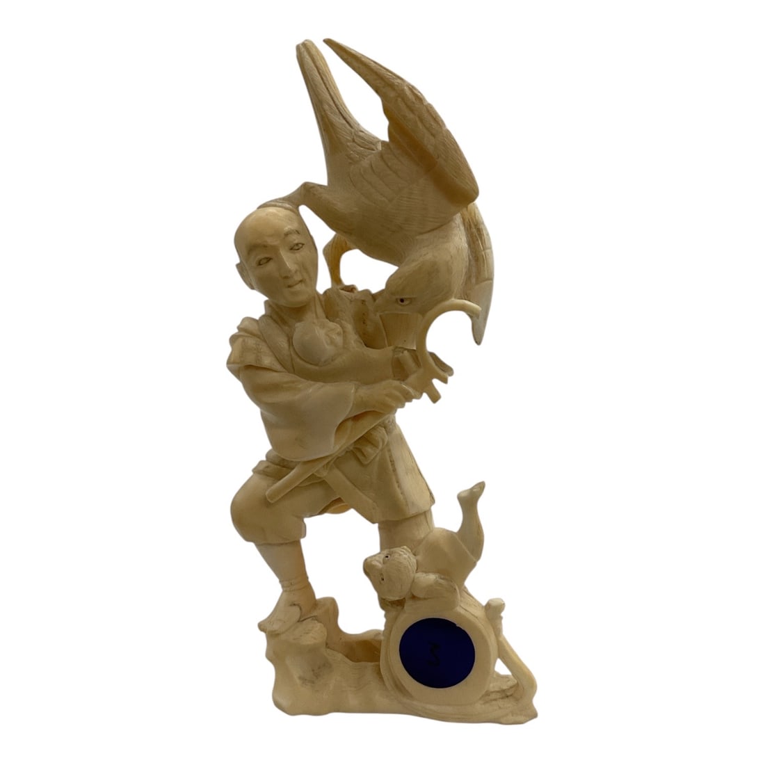 Asian-Style Carved Fisherman with Large Bird Figural Sculpture: A detailed Asian-style carved figural sculpture depicting a standing fisherman or attendant holding a large bird, possibly a cormorant, with its wings dramatically raised. The figure is posed upon a n