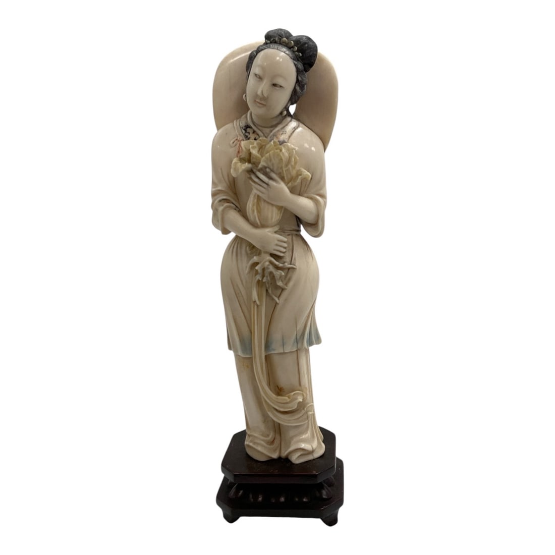Asian-Style Carved Female Figure Holding Flowers Sculpture: A finely detailed Asian-style carved sculpture depicting an elegant standing female figure holding a bouquet of flowers close to her chest. The figure is dressed in flowing traditional garments with d