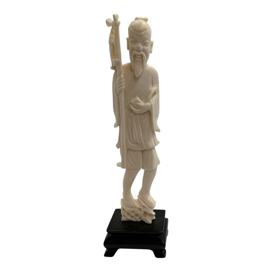 Asian-Style Carved Bearded Elder with Staff Sculpture: A detailed Asian-style carved figural sculpture depicting a standing bearded elder or sage dressed in flowing traditional robes and holding a tall staff. The figure features an elongated beard,