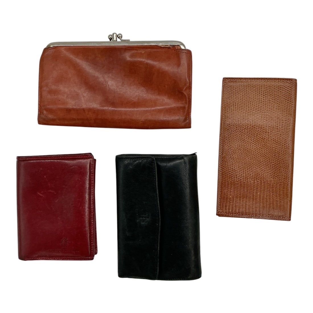 Collection of Four Vintage Leather Wallets and Coin Purse: Collection of four vintage leather accessories including wallets, a billfold, and a clasp coin purse. The assortment features brown, black, and burgundy leather examples in a variety of styles,
