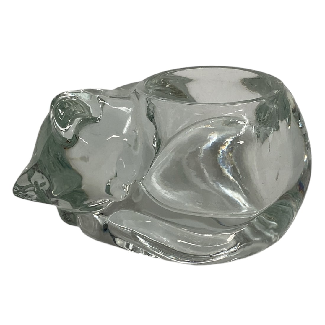 Clear Crystal Sleeping Cat Figurine: Decorative clear crystal figurine depicting a curled sleeping cat in a compact resting pose. The sculpture features a rounded body with modeled ears, facial details, folded paws, and flowing contours 