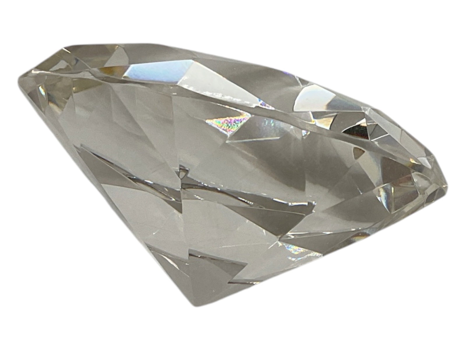 Large Faceted Crystal Diamond Paperweight: Decorative clear crystal paperweight designed in the form of a large brilliant-cut diamond. The piece features numerous precision-style facets across the crown and body, creating strong light