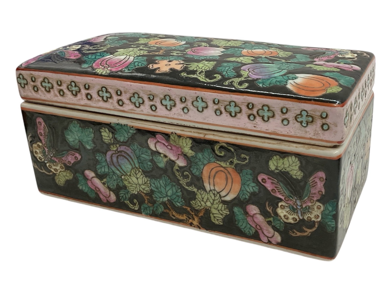 Chinese Famille Noire Porcelain Floral & Butterfly Covered Box: Decorative Chinese porcelain covered box featuring a rectangular form with a fitted removable lid and a rich black ground. The exterior is densely decorated with colorful flowering vines, lotus and pe