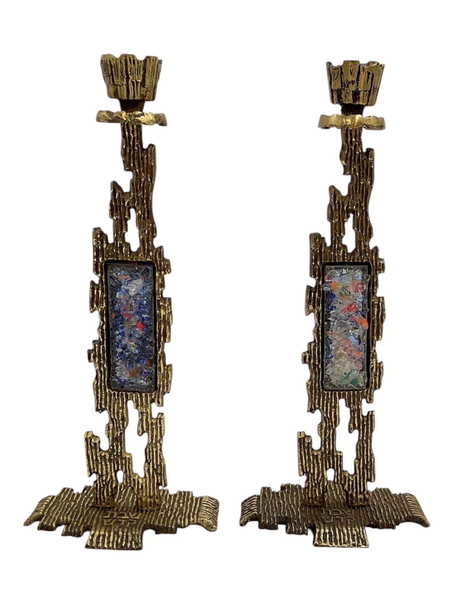 Pair of Vintage Brutalist Brass Candlesticks with Enamel Panels: Pair of vintage sculptural candlesticks featuring an abstract Brutalist-style design in textured brass-tone metal. Each tall candlestick is constructed with irregular geometric openwork elements, a br