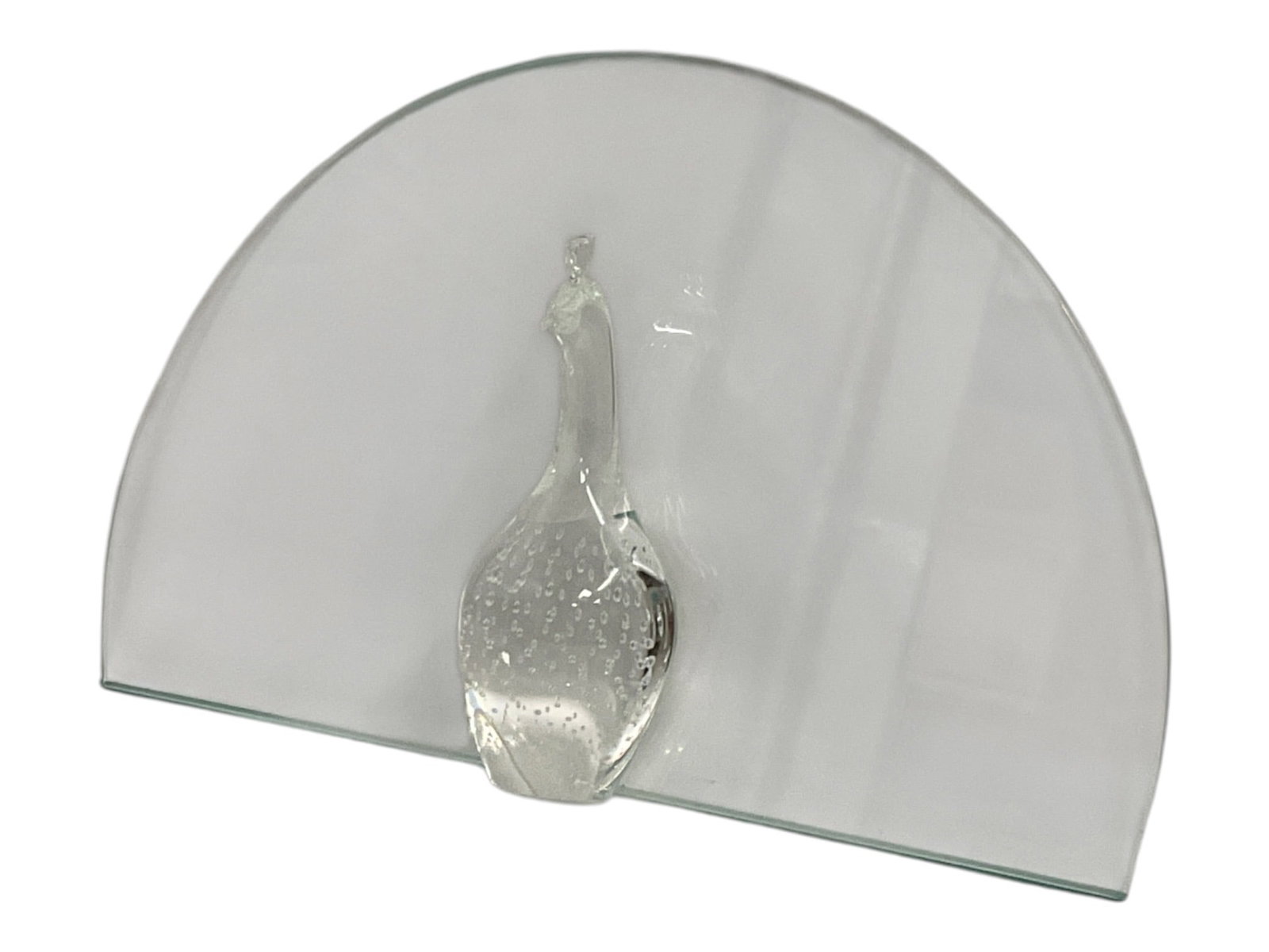 Art Glass Peacock Sculpture with Curved Glass Fan: Decorative art glass sculpture featuring a stylized clear glass peacock positioned against a large semicircular fan-shaped glass backdrop. The peacock features an elongated neck and a textured, bubble