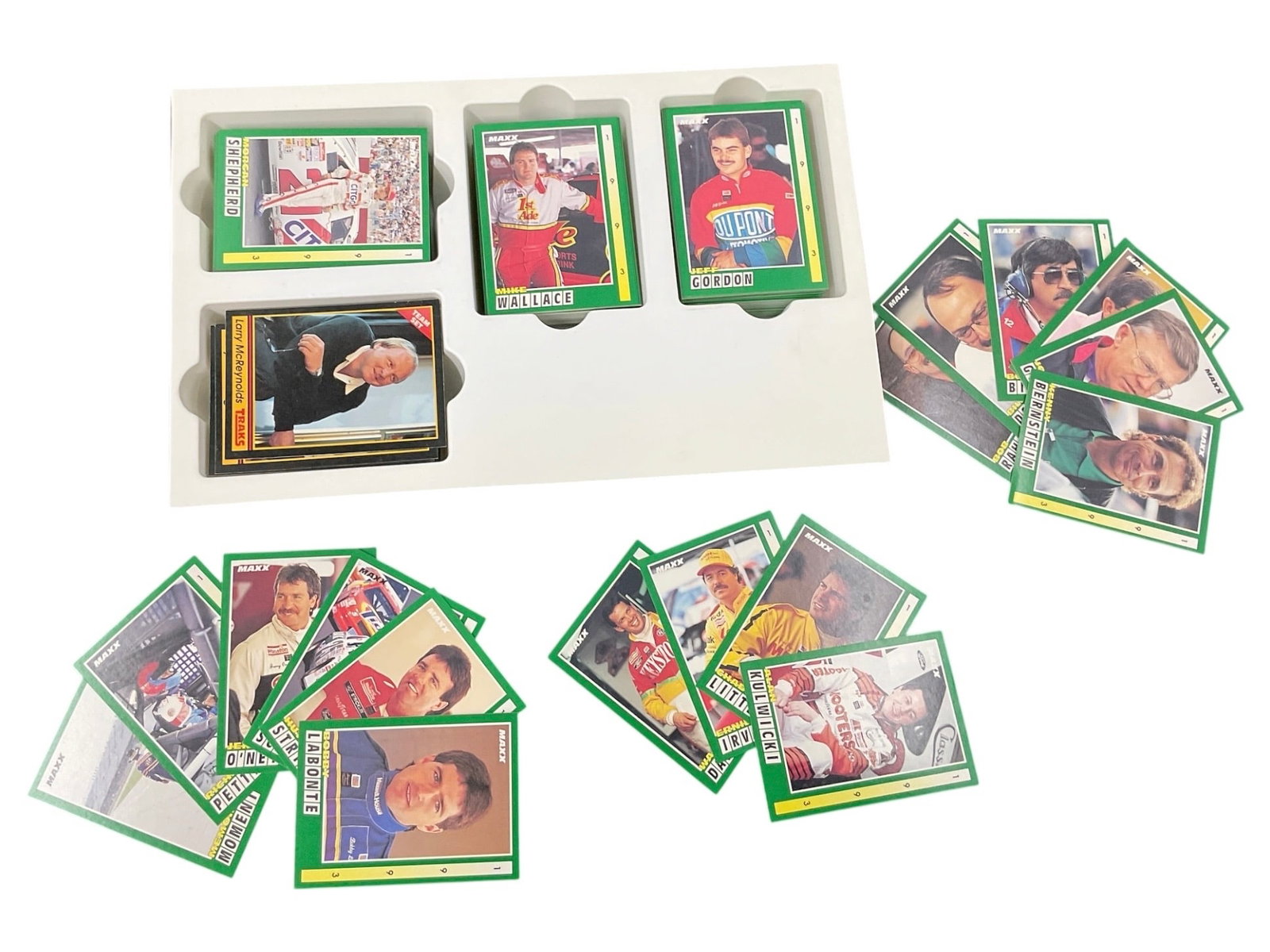 Assorted NASCAR Racing Trading Card Collection: Collection of assorted NASCAR and stock car racing trading cards featuring numerous drivers and racing personalities. The grouping includes multiple green-bordered racing cards along with several