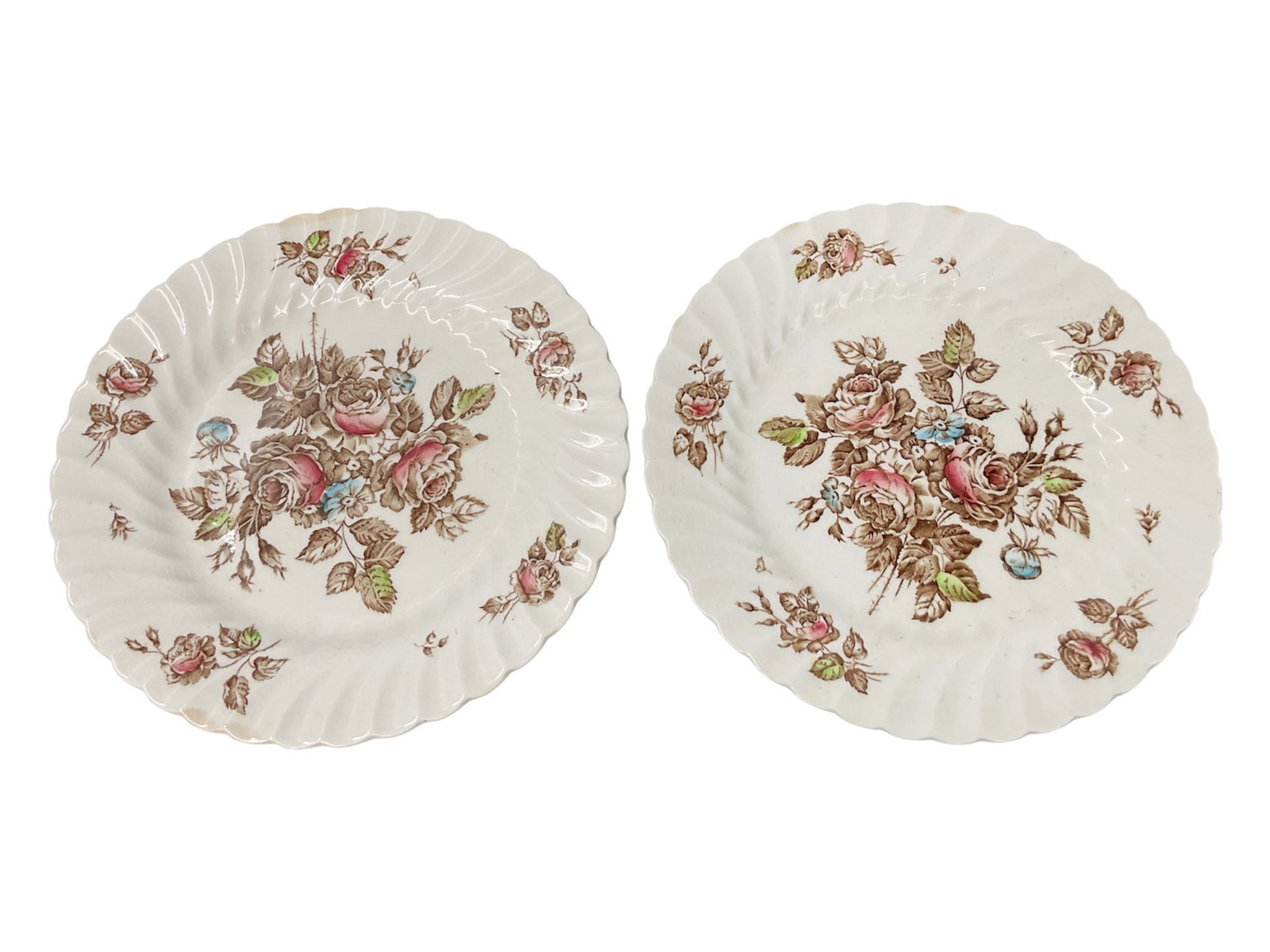 Pair of Devon Sprays by Johnson Bros Ironstone Dinner Plates: A charming pair of English ironstone dinner plates in the “Devon Sprays” pattern by Johnson Bros. Each plate features a softly scalloped rim with a delicate floral design of roses and