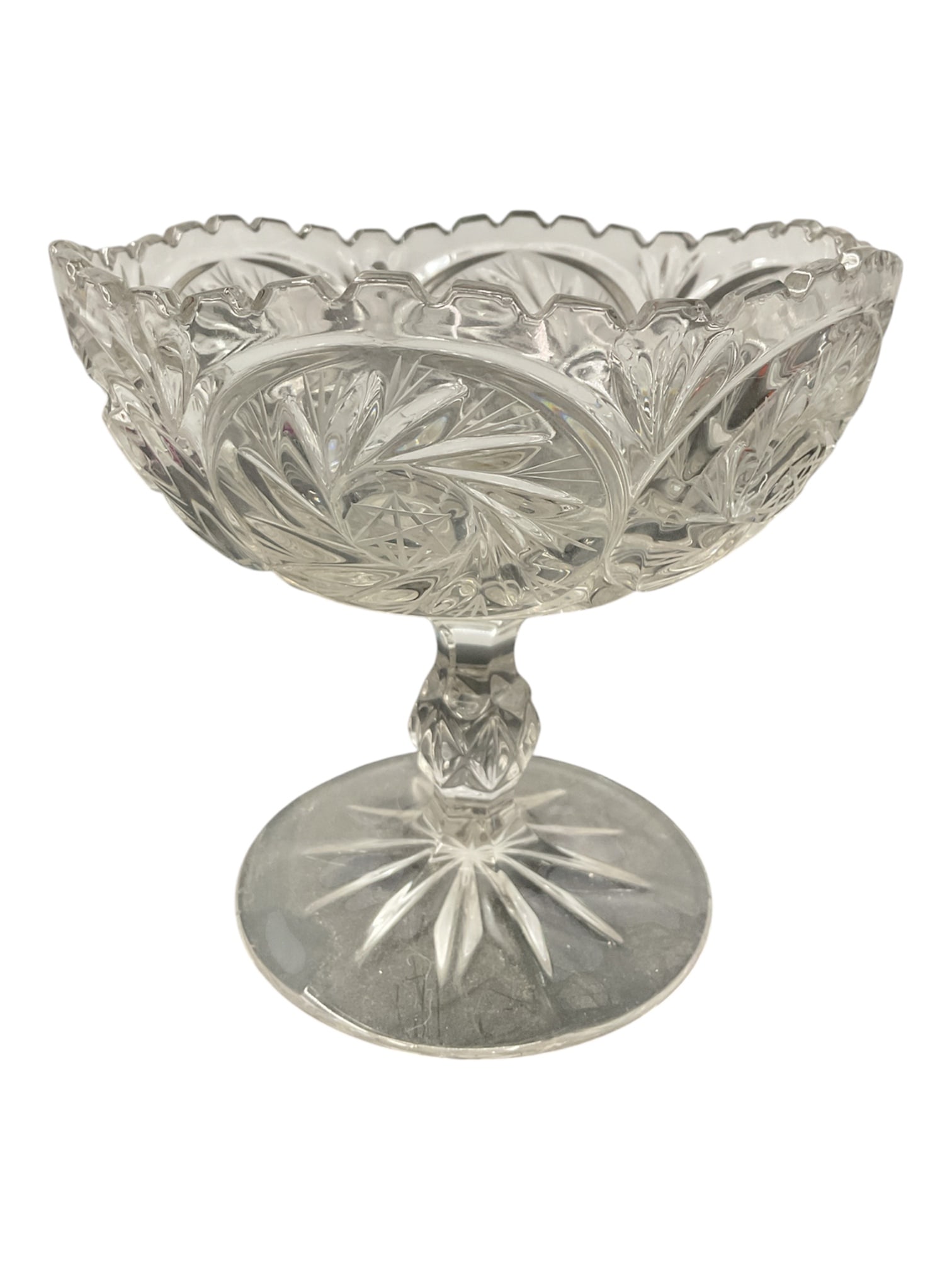 Cut Crystal Compote Bowl with Scalloped Rim and Starburst Base: Decorative cut crystal compote bowl featuring a classic pedestal form with a wide, shallow dish and scalloped rim. The bowl is adorned with finely cut geometric and fan patterns, including repeating o