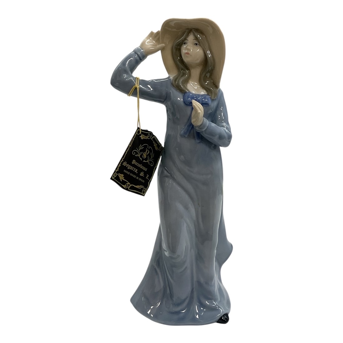 Porcelanas Segarra Spanish Porcelain Lady Figurine: Vintage Spanish porcelain figurine by Porcelanas Segarra of Valencia, depicting an elegant young woman in a flowing blue-gray gown. The figure is modeled with long brown hair, one hand raised to her