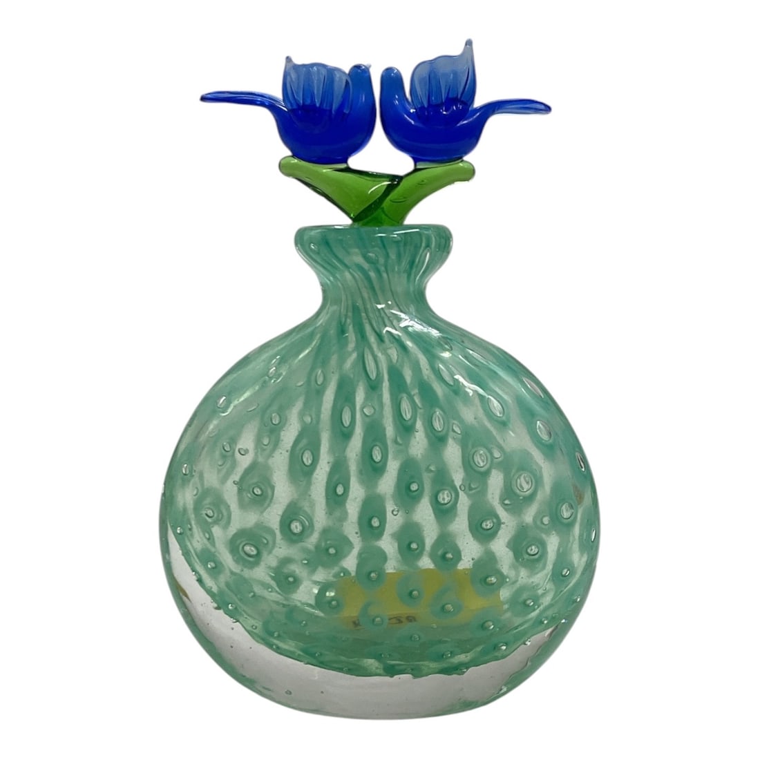 Seafoam Green Art Glass Perfume Bottle with Blue Floral Stopper: Decorative hand-blown art glass perfume or scent bottle featuring a rounded seafoam green body with an applied controlled-bubble pattern. The bottle is topped by an elaborate lampwork-style stopper