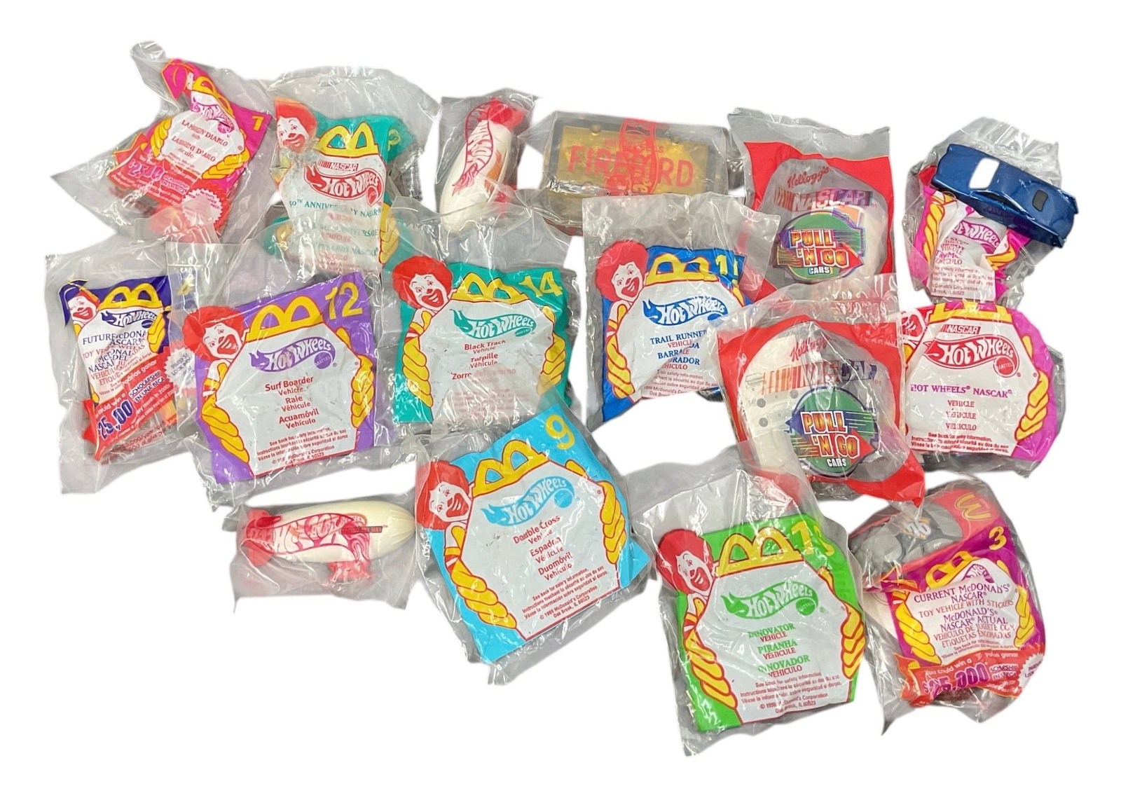 Lot of 16 Vintage McDonald’s Hot Wheels Happy Meal Toys in Original Packaging: Collection of 16 vintage Hot Wheels toys issued through McDonald’s Happy Meal promotions, with the toys retained in their original individual plastic packaging. The assortment includes various