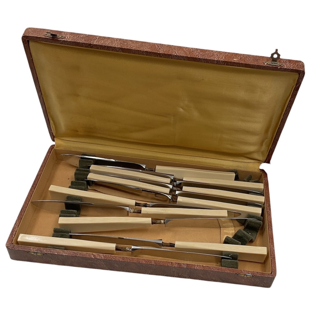 Set of Eleven Stainless Steel Dinner Knives in Presentation Box: Set of eleven stainless steel dinner knives featuring tapered handles in a clean, mid-century modern design. The knives are housed in their original fitted presentation box with satin-lined lid and