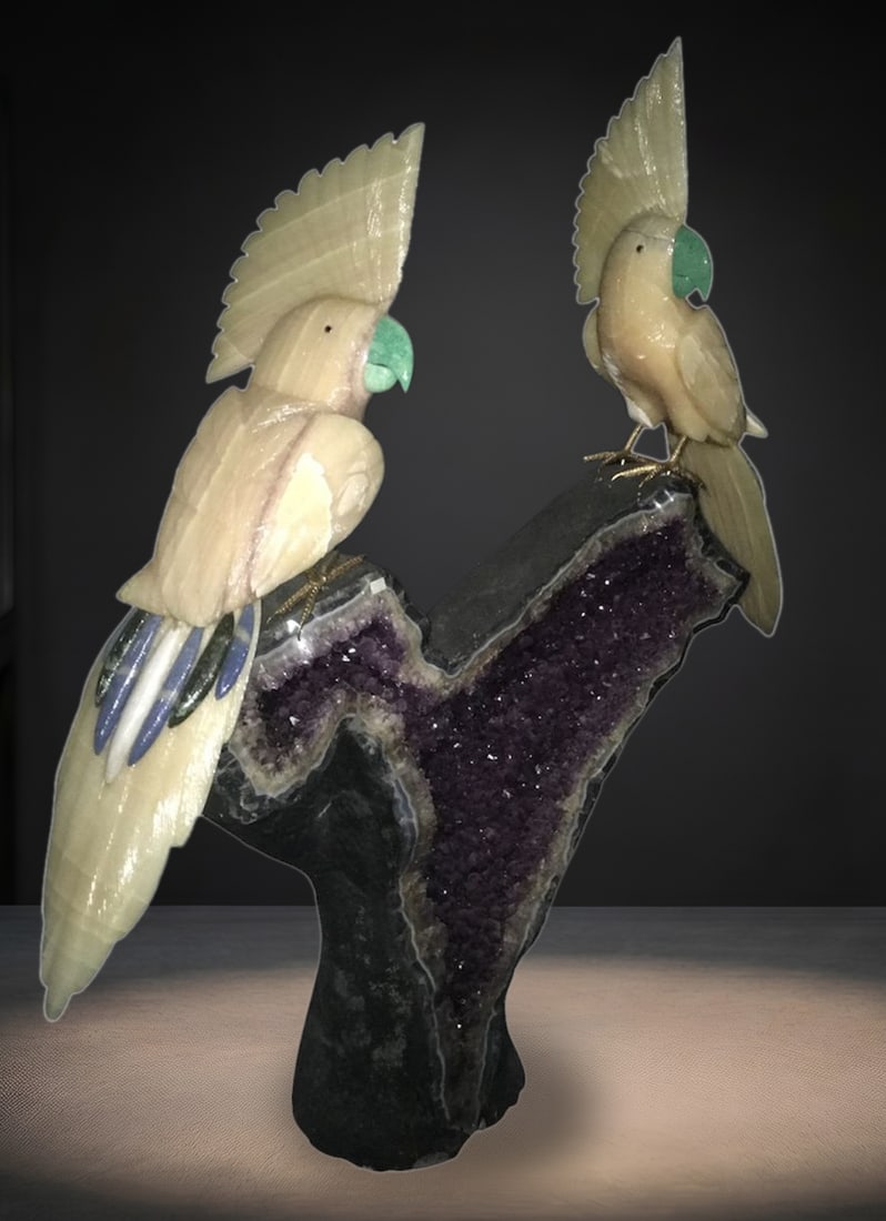 Monumental Amethyst Geode Cathedral with Hand-Carved Gemstone Cockatoos: An exceptional and imposing showpiece, this monumental Brazilian amethyst geode cathedral features two masterfully hand-carved gemstone cockatoos perched atop its natural volcanic matrix. The massive