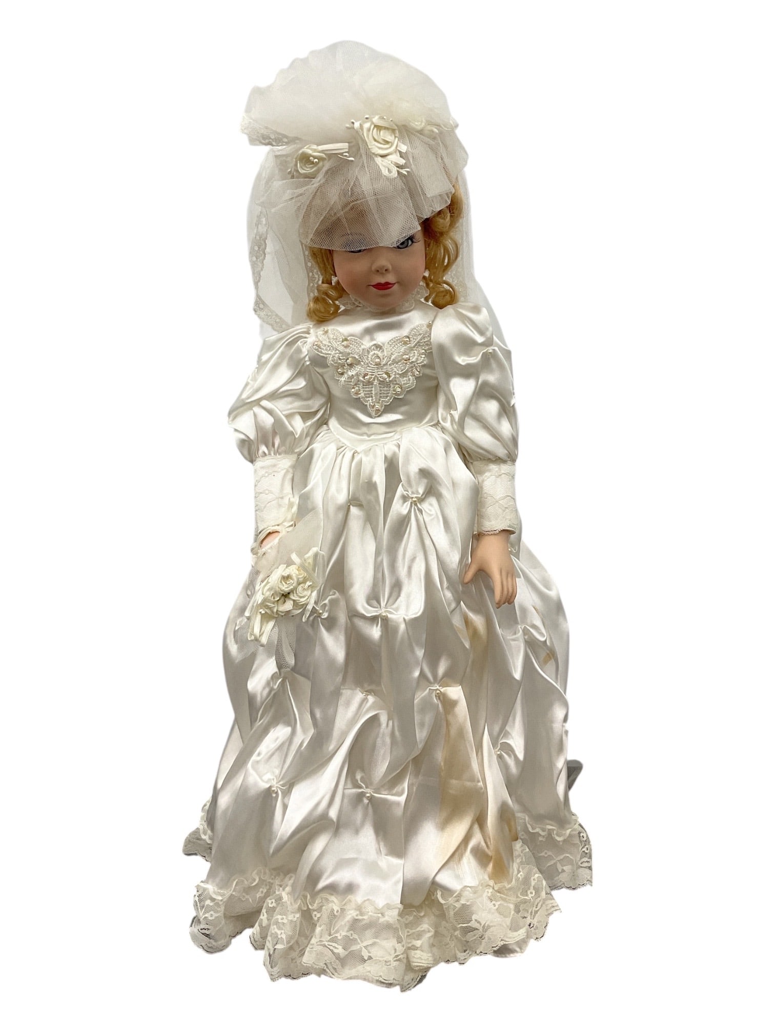 Porcelain Bride Doll in Satin Wedding Gown with Lace Veil: Decorative porcelain collector doll dressed as a traditional bride in an elaborate white satin wedding gown. The doll features a porcelain-style face with painted features and styled hair beneath a br