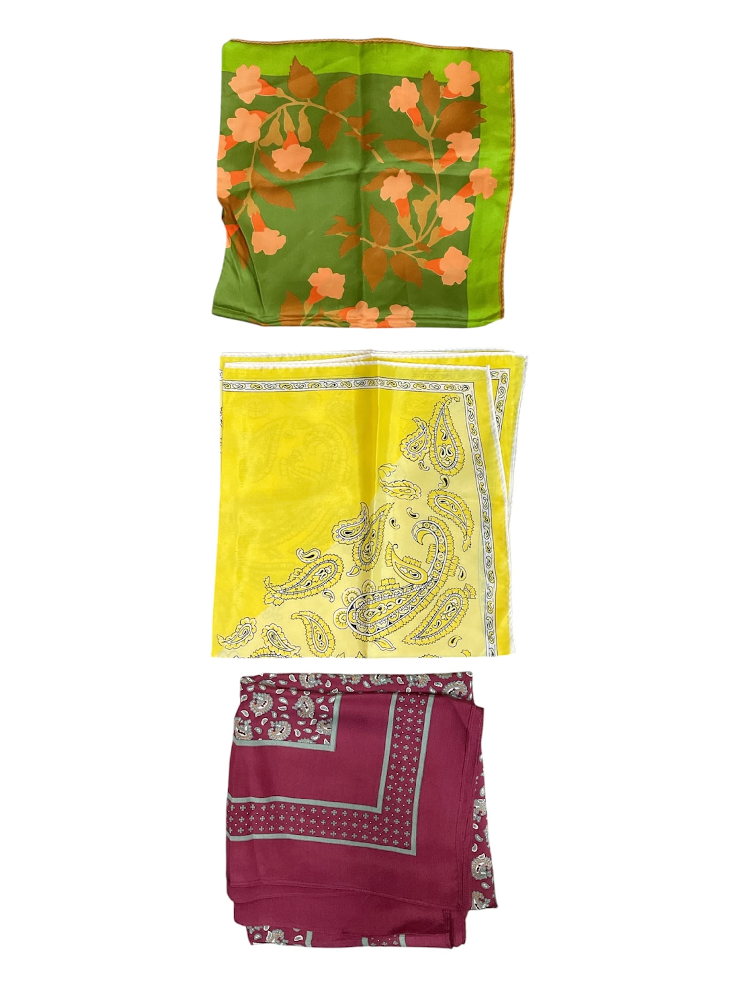 Group of Three Vintage Fashion Scarves with Floral and Paisley Designs: Collection of three vintage fashion scarves featuring floral and paisley-inspired decorative motifs. Includes a green floral scarf signed “Vera,” a yellow paisley-print scarf with contrast