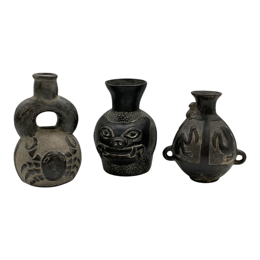 Group of Three Chimu Blackware Pottery Vessels: Group of three Chimu culture blackware pottery vessels from Peru, featuring traditional stirrup and effigy forms with incised and relief decoration. The group includes zoomorphic and geometric motifs 