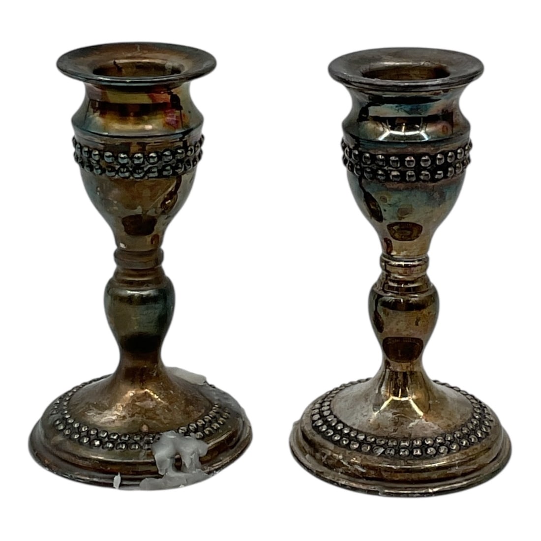 Pair of Silver Tone Candlesticks with Beaded Detail: A decorative pair of silver tone candlesticks featuring a classic form with tiered stems and circular bases accented by raised beaded detailing. The design offers a traditional aesthetic with subtle o
