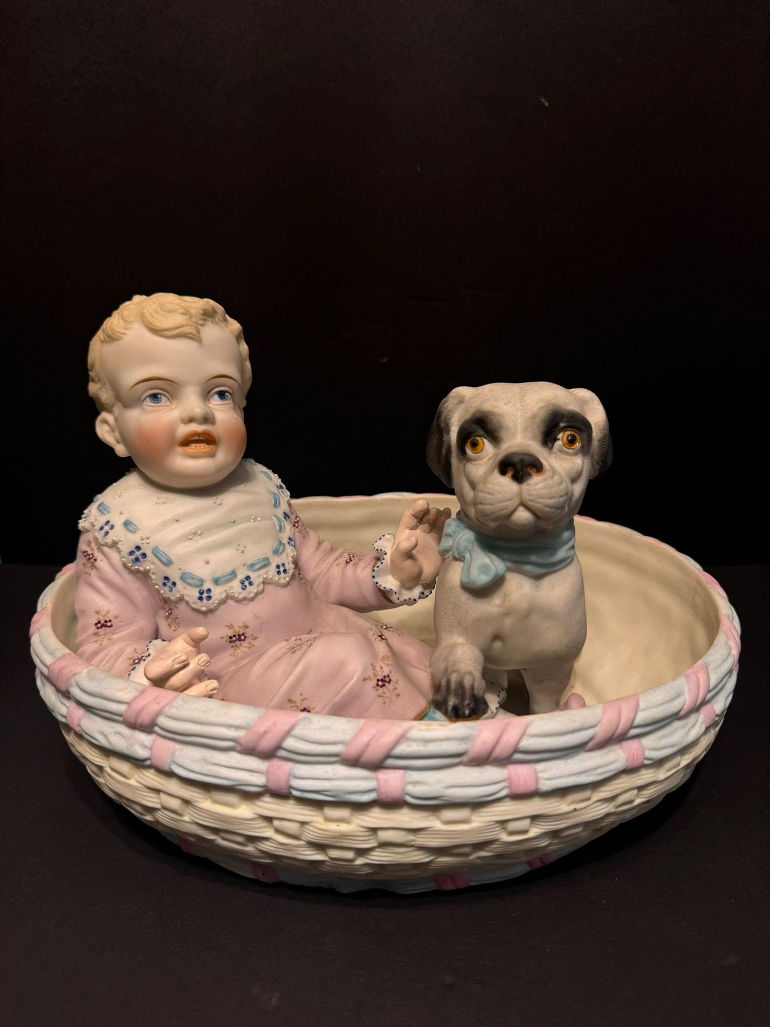 German Bisque Porcelain Figurine of Baby and Dog in Basket: Specifications Origin: Germany <