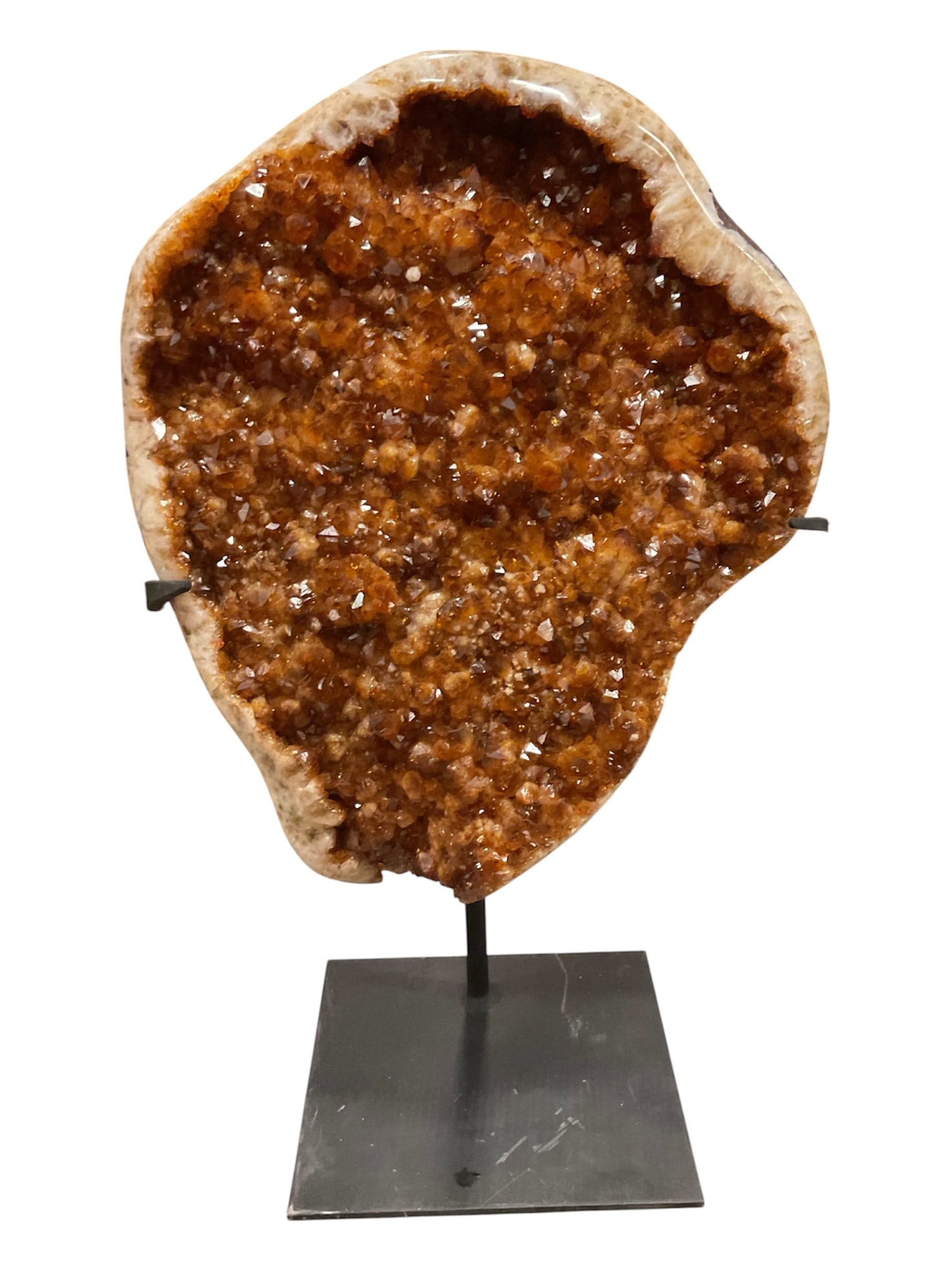 Large Citrine Quartz Geode Crystal Cluster on Metal Stand: A substantial natural quartz geode displaying a dense interior of sparkling amber-orange and golden-brown crystal points. The richly colored crystalline surface is surrounded by a contrasting pale cre